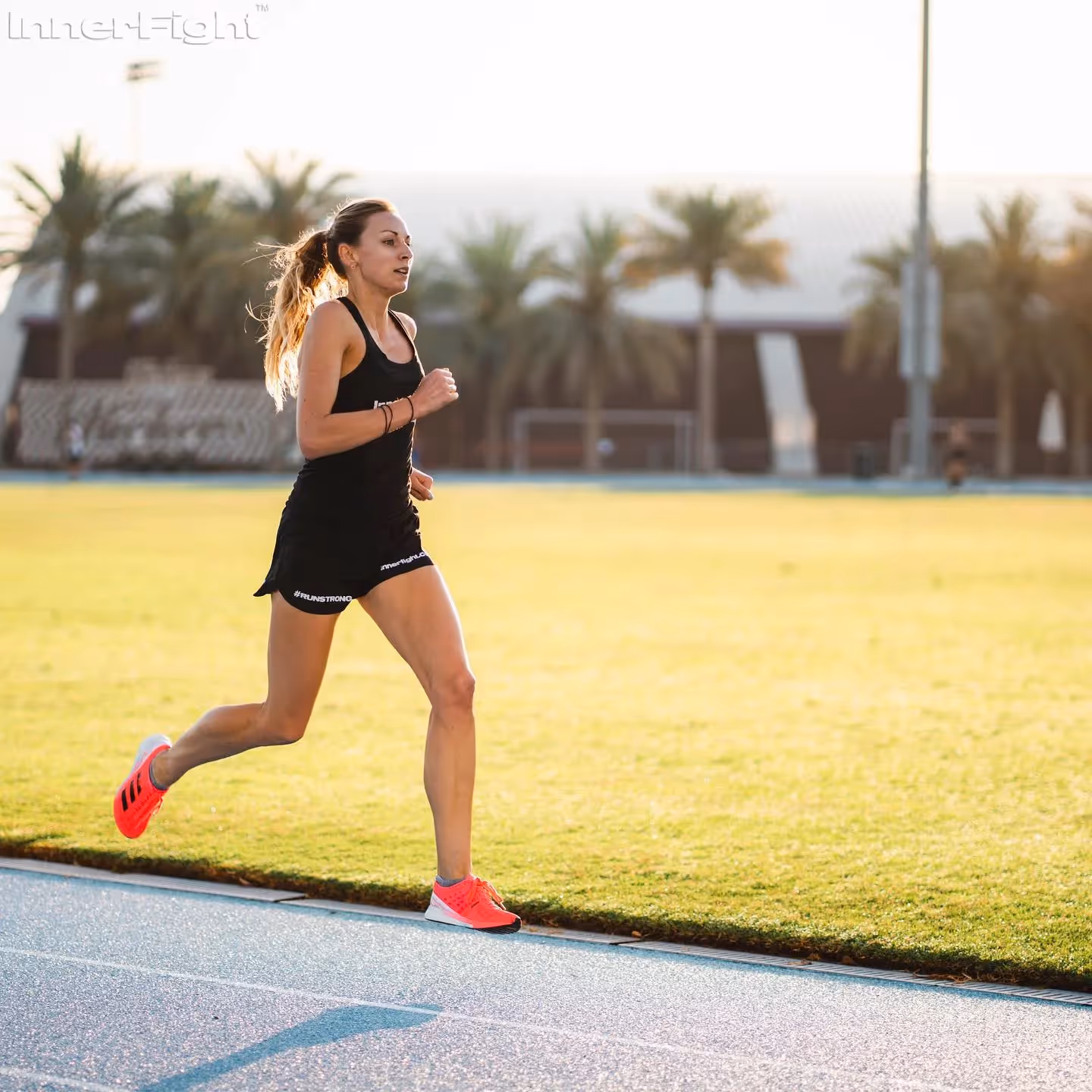 Female athlete running on a track in dubai