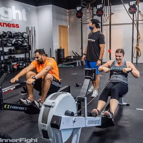 InnerFight athlete on a rowing machine during a fitness class