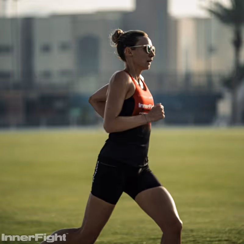 Female athlete running on a track in Dubai