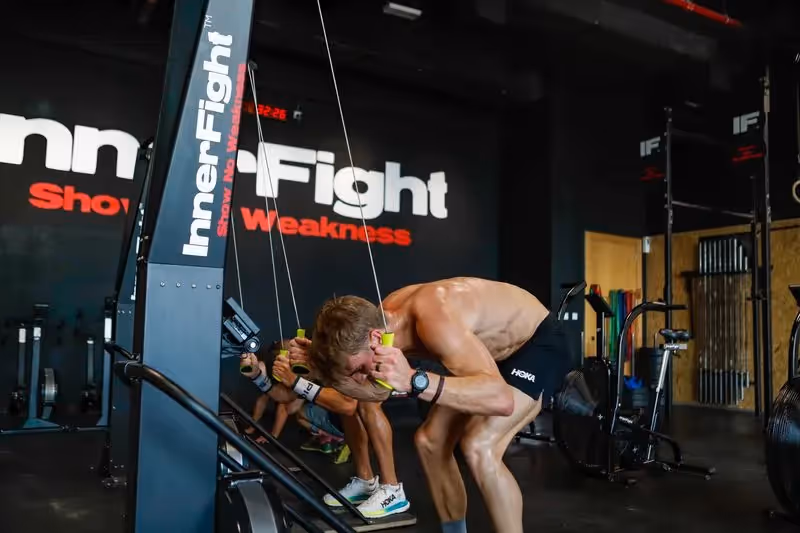 Athletes in CrossFit gym using SkiErg equipment