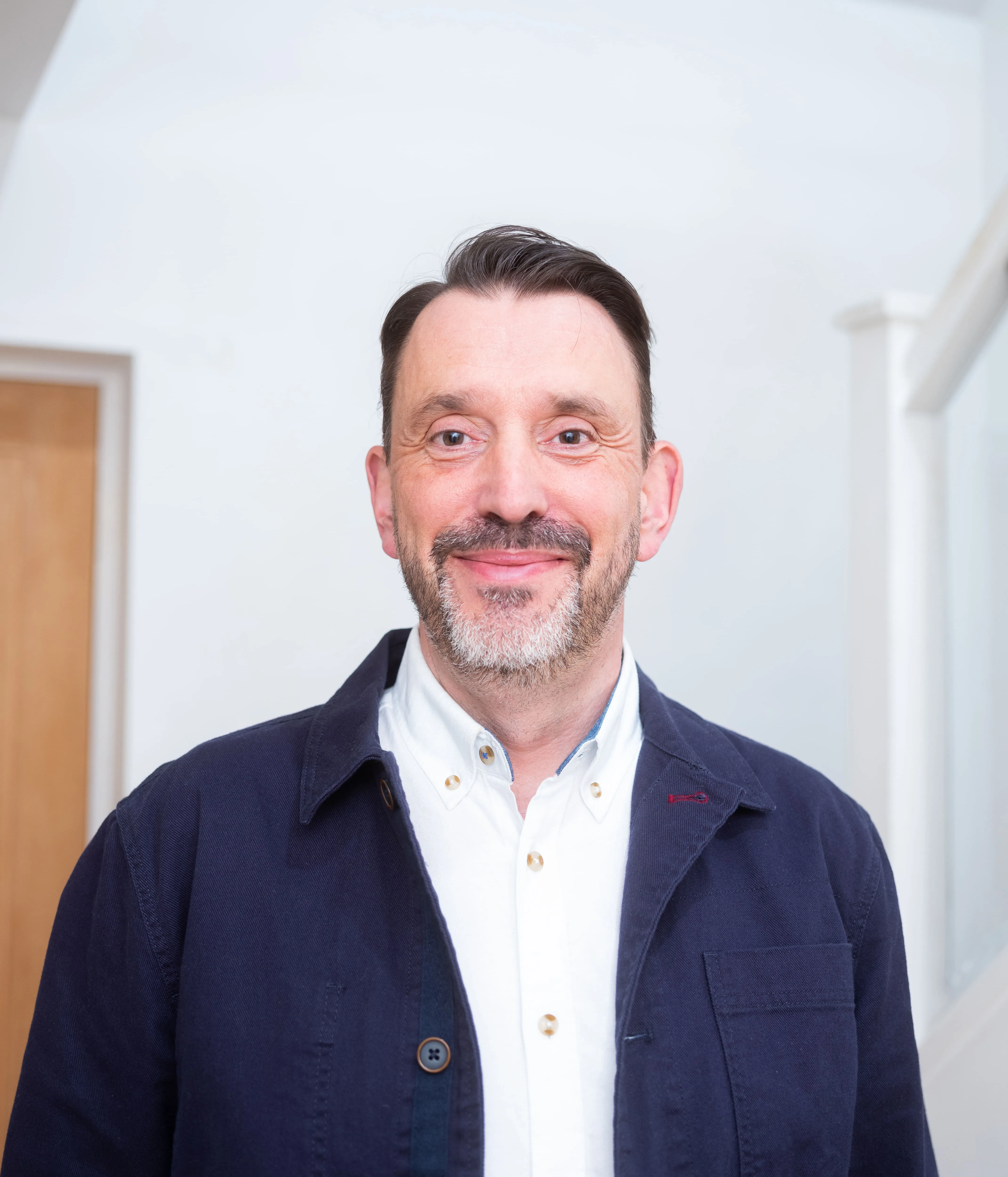 a man smiles at the camera