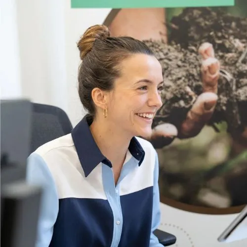 a woman sitting in front of a computer monitor