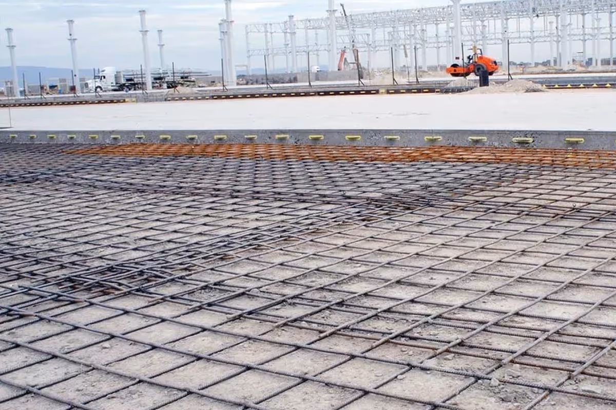 American Highway’s welded wire mesh installed in warehouse concrete flatwork, reinforcing slabs for high-traffic durability. Close-up of epoxy-coated welded wire mesh in industrial flatwork, ensuring crack-free concrete stability.