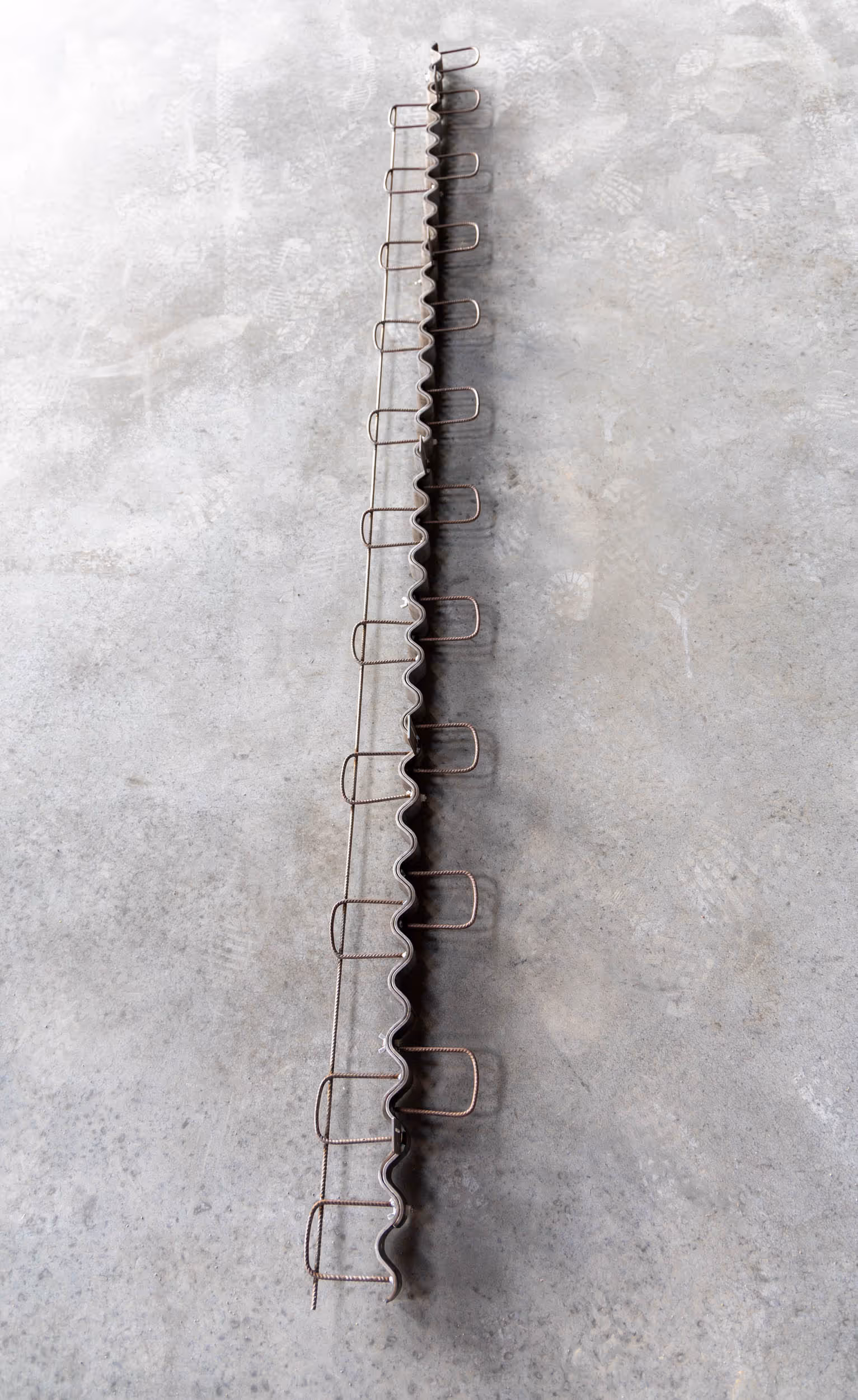 American Highway’s Serpentine™ Joint Assembly installed in warehouse concrete flatwork, ensuring shock-free load transfer and durable joints. Close-up of Serpentine™ Joint Assembly in cold storage flatwork, providing curl-free, stable concrete joints for high-traffic environments.