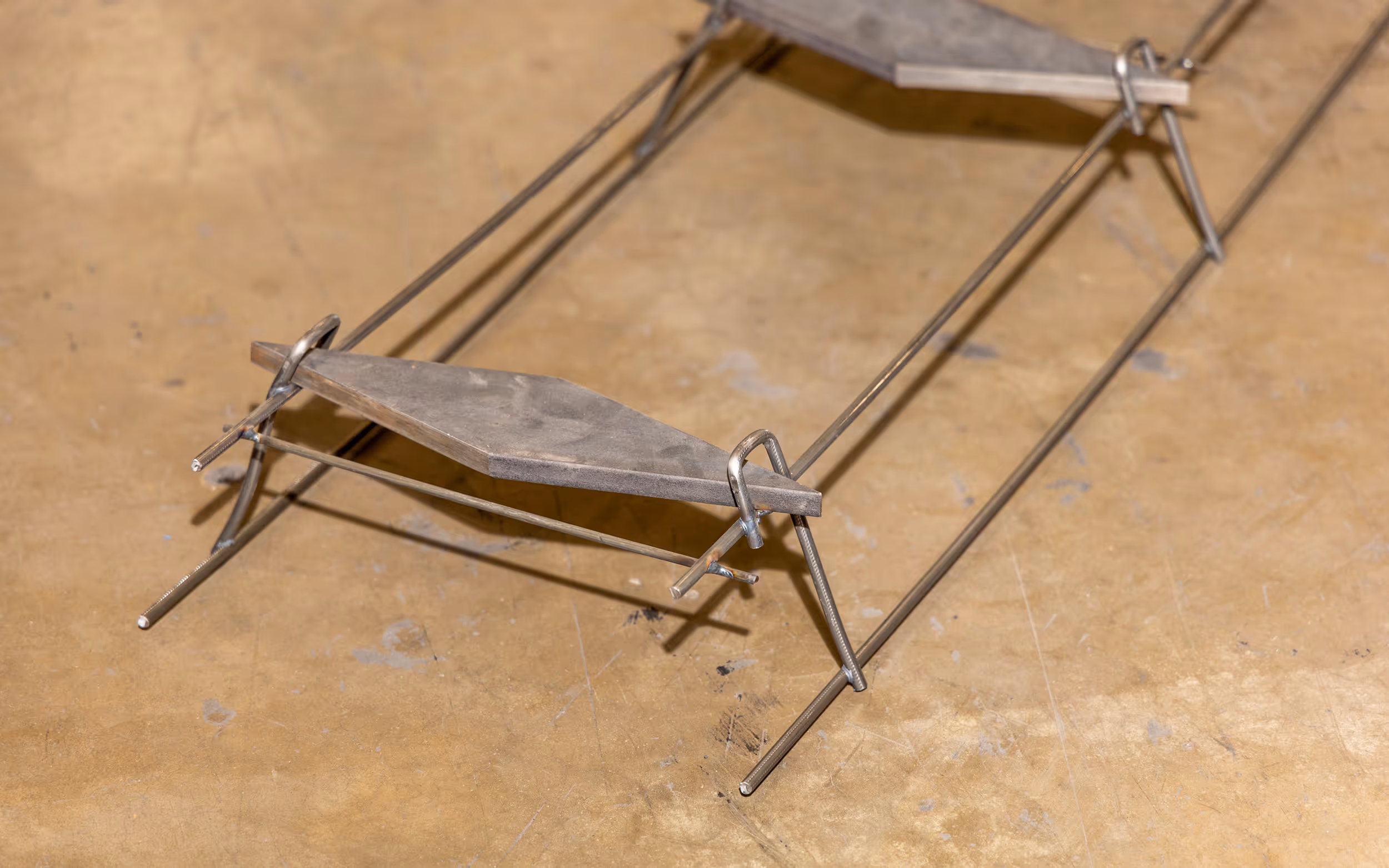 American Highway’s American DT™ Assembly with double-tapered dowels installed in warehouse concrete flatwork, ensuring precise joint stability. Close-up of American DT™ Assembly in industrial flatwork, providing robust load transfer for high-traffic concrete joints.