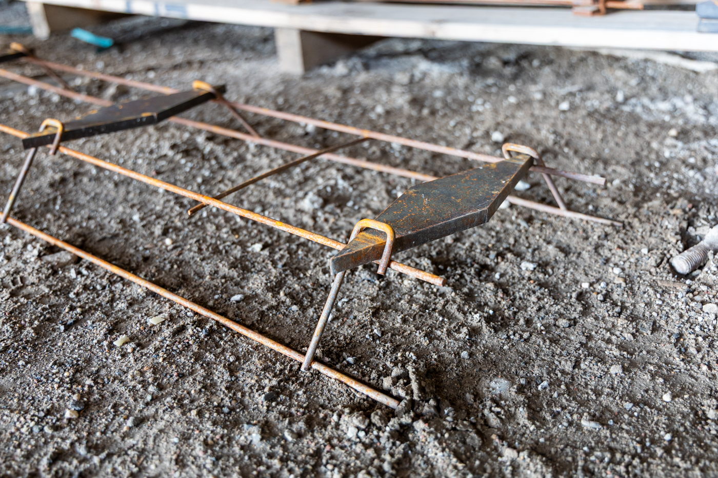 American Highway’s American DT™ Assembly with double-tapered dowels installed in warehouse concrete flatwork, ensuring precise joint stability. Close-up of American DT™ Assembly in industrial flatwork, providing robust load transfer for high-traffic concrete joints.