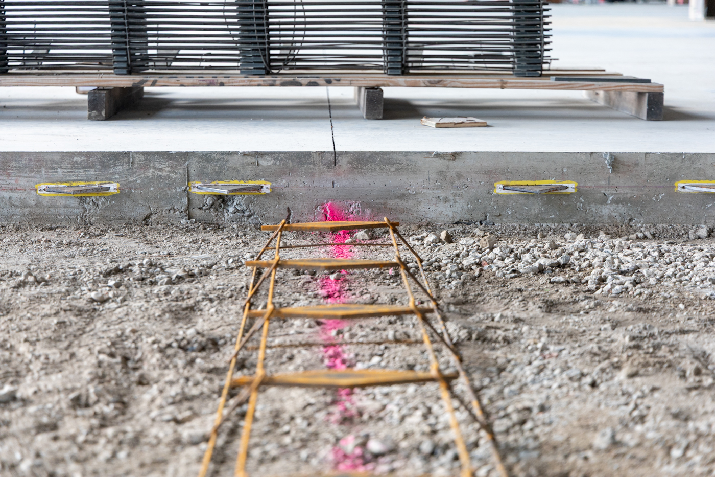 American Highway’s American DT™ Assembly with double-tapered dowels installed in warehouse concrete flatwork, ensuring precise joint stability. Close-up of American DT™ Assembly in industrial flatwork, providing robust load transfer for high-traffic concrete joints.