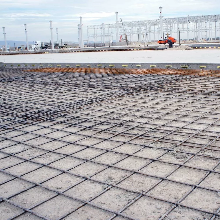 American Highway’s welded wire mesh installed in warehouse concrete flatwork, reinforcing slabs for high-traffic durability. Close-up of epoxy-coated welded wire mesh in industrial flatwork, ensuring crack-free concrete stability.