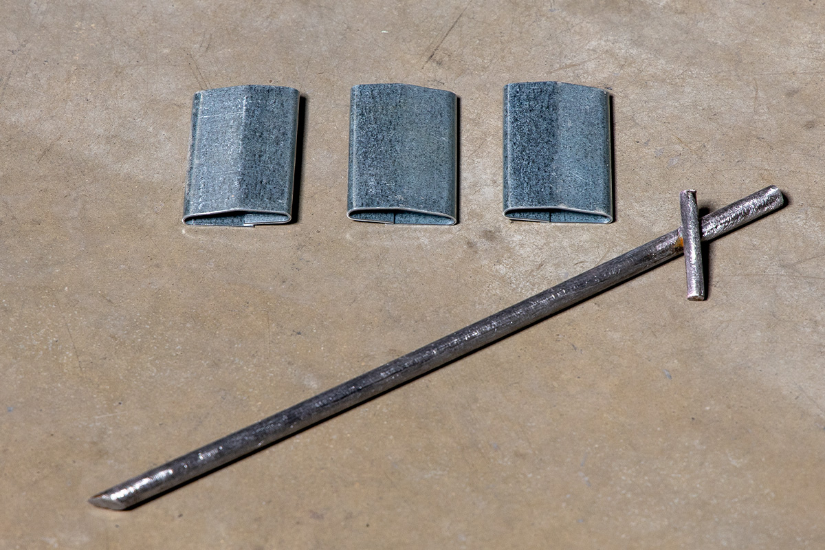 American Highway’s stakes, pins, and clips securing road fabric in warehouse concrete flatwork, ensuring stable, high-traffic durability. Close-up of American Highway’s pins and clips in industrial flatwork, aligning reinforcement for robust concrete performance.