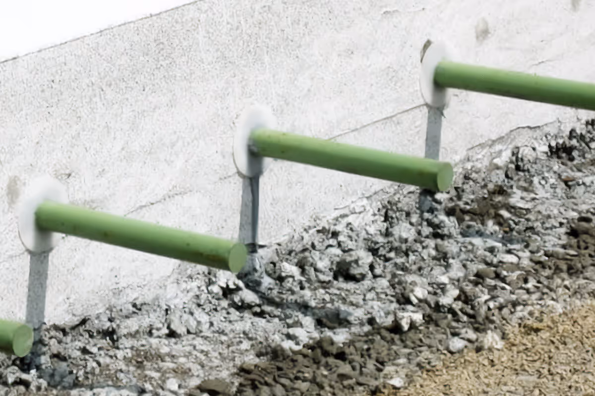 American Highway’s epoxy adhesive applied in warehouse concrete flatwork, securing dowels for durable, high-traffic joints. Close-up of epoxy adhesive in industrial flatwork, ensuring strong anchoring and crack-resistant concrete surfaces.