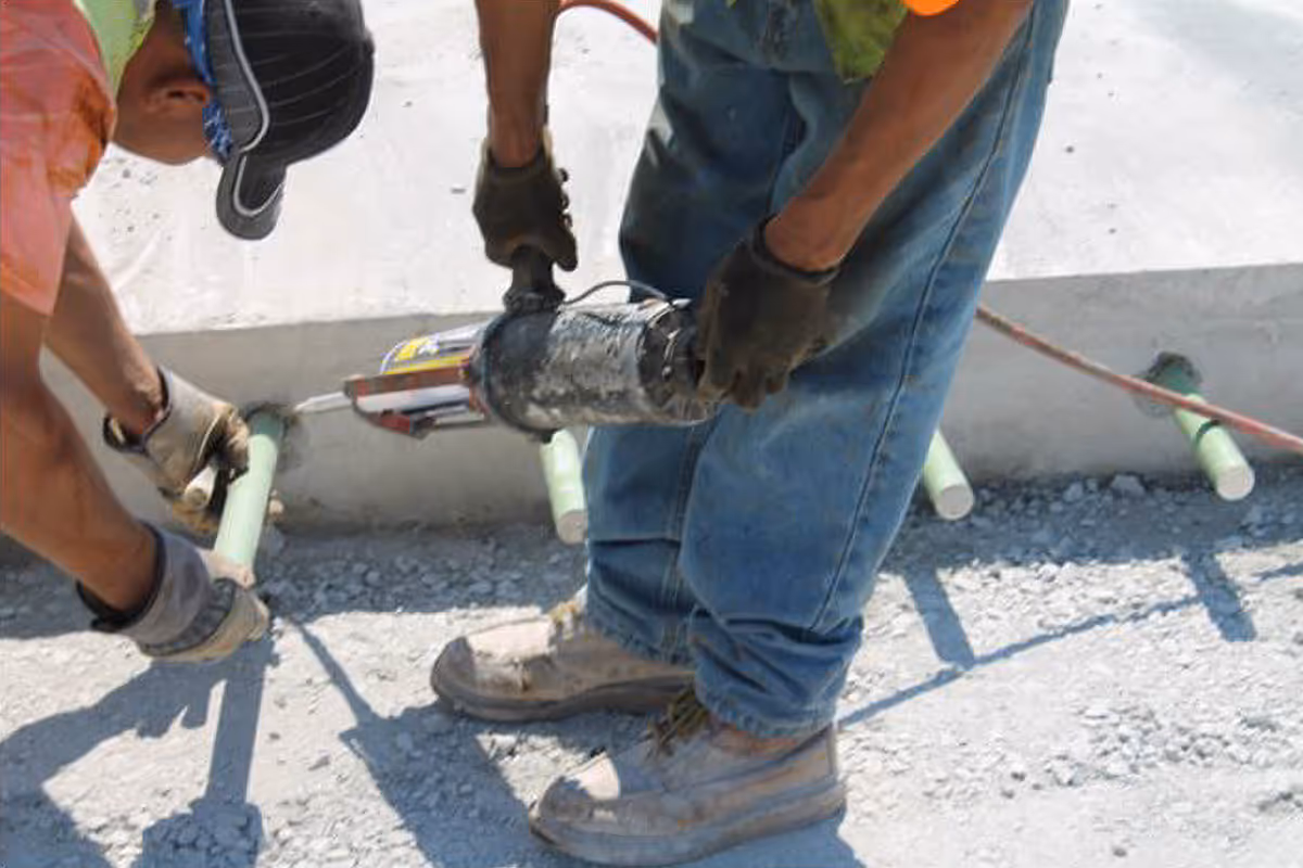 American Highway’s epoxy adhesive applied in warehouse concrete flatwork, securing dowels for durable, high-traffic joints. Close-up of epoxy adhesive in industrial flatwork, ensuring strong anchoring and crack-resistant concrete surfaces.