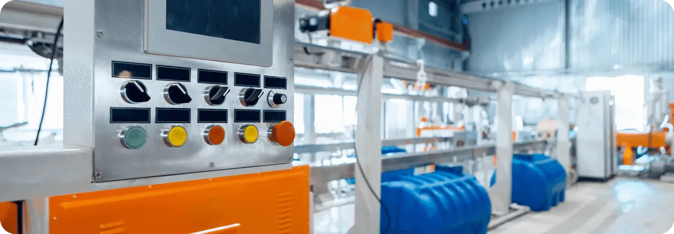 a factory with a lot of blue and orange barrels