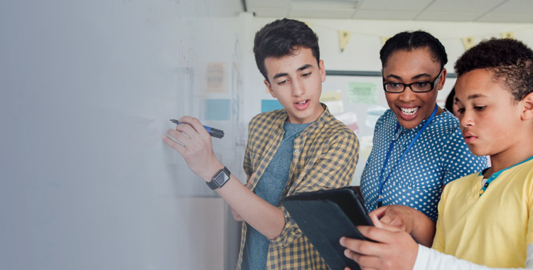 Image of high school students using the white board