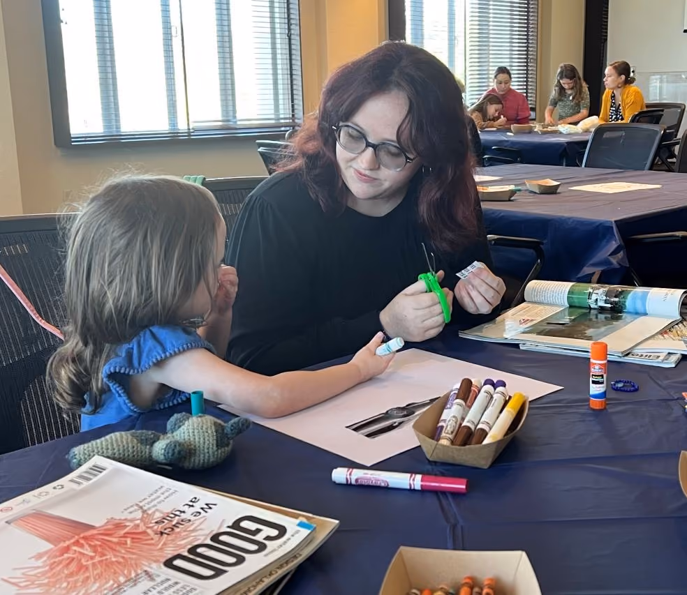 A mother and daughter work on a collage art project together during a Saturday free artist workshop.