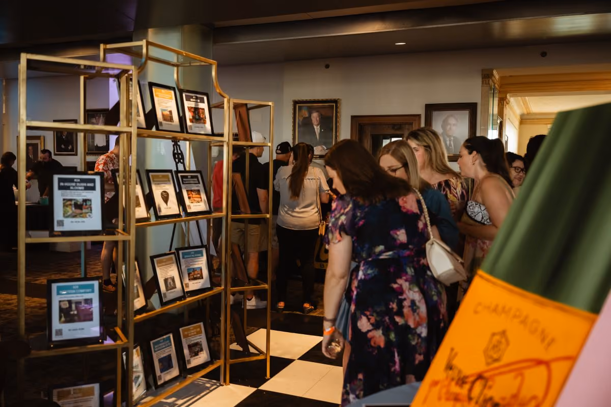A group of women look at the silent auction package options.