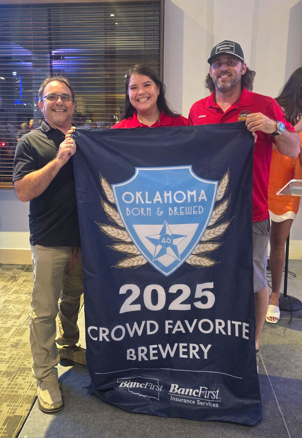 Mountain Fork Brewery holds up their Crowd Favorite Brewery banner.