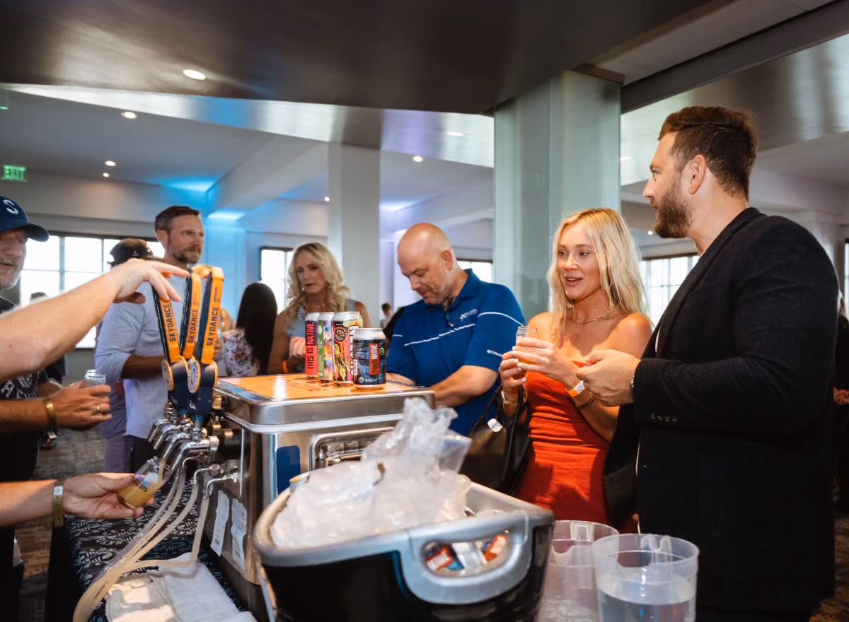 Attendees get samples of beer from Skydance Brewery.