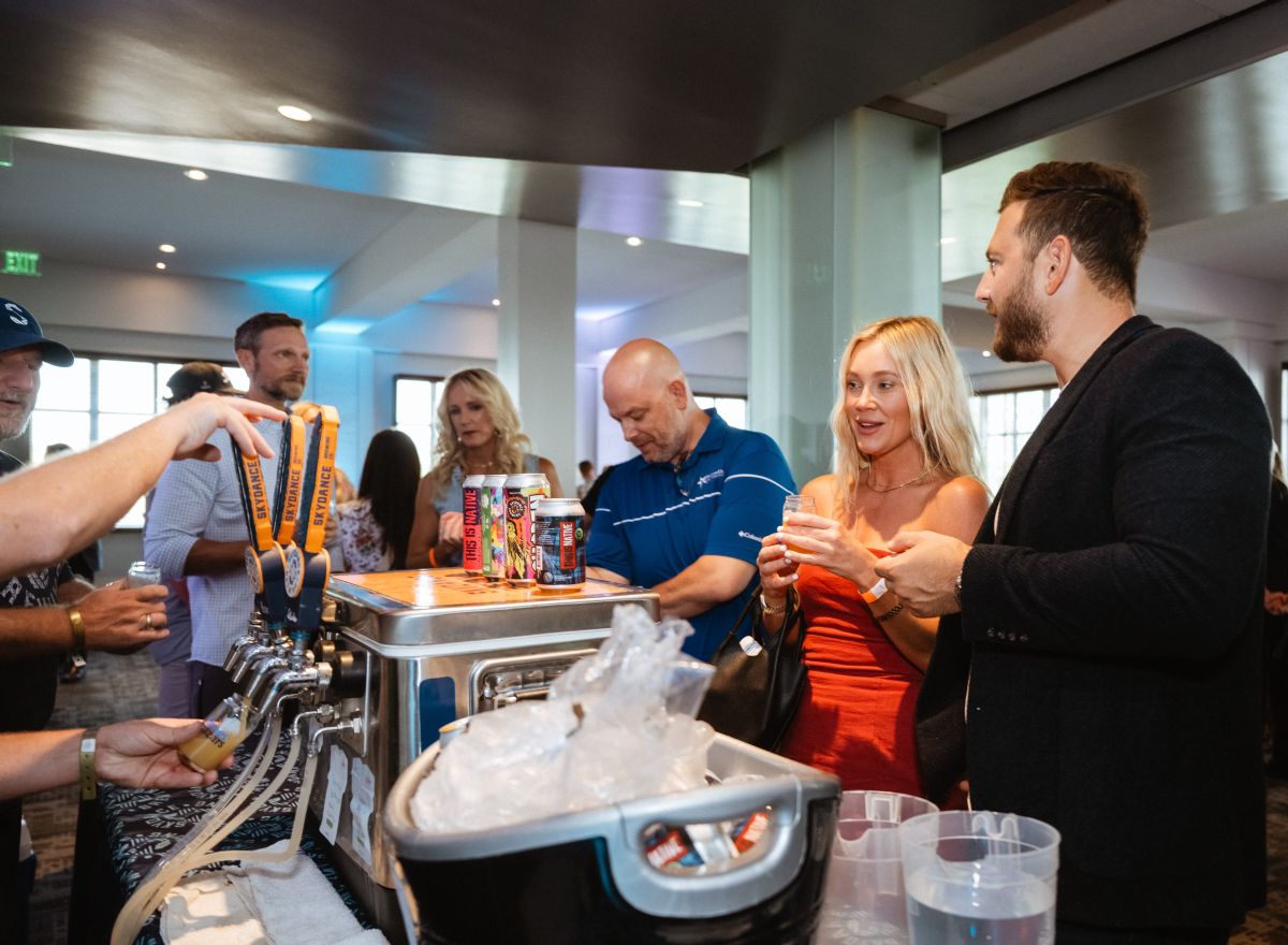 Attendees get samples of beer from Skydance Brewery.