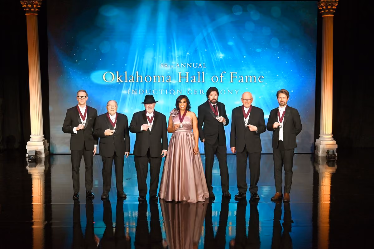 2025 Inductees Sam Presti, Dr. Michael Mares, Eddy Gibbs, Dr. Mautra Staley Jones, Ronnie Dunn, Bert Mackie, and Taylor Hanson pose together on stage with their Medallions.