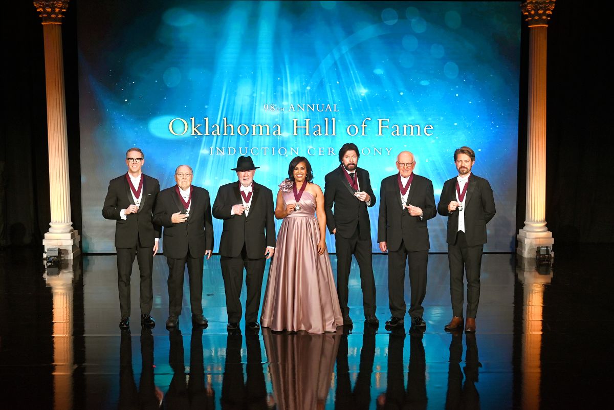 2025 Inductees Sam Presti, Dr. Michael Mares, Eddy Gibbs, Dr. Mautra Staley Jones, Ronnie Dunn, Bert Mackie, and Taylor Hanson pose together on stage with their Medallions.