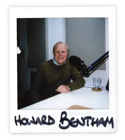 Polaroid of Howard Bentham in the Oxford Podcast Studio sat at the table with a microphone.