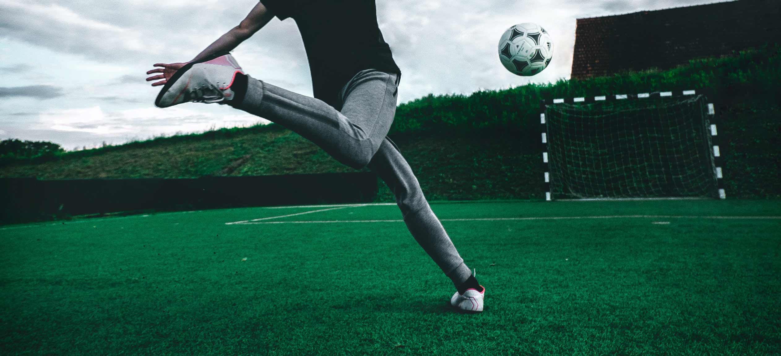 Man kicking a football