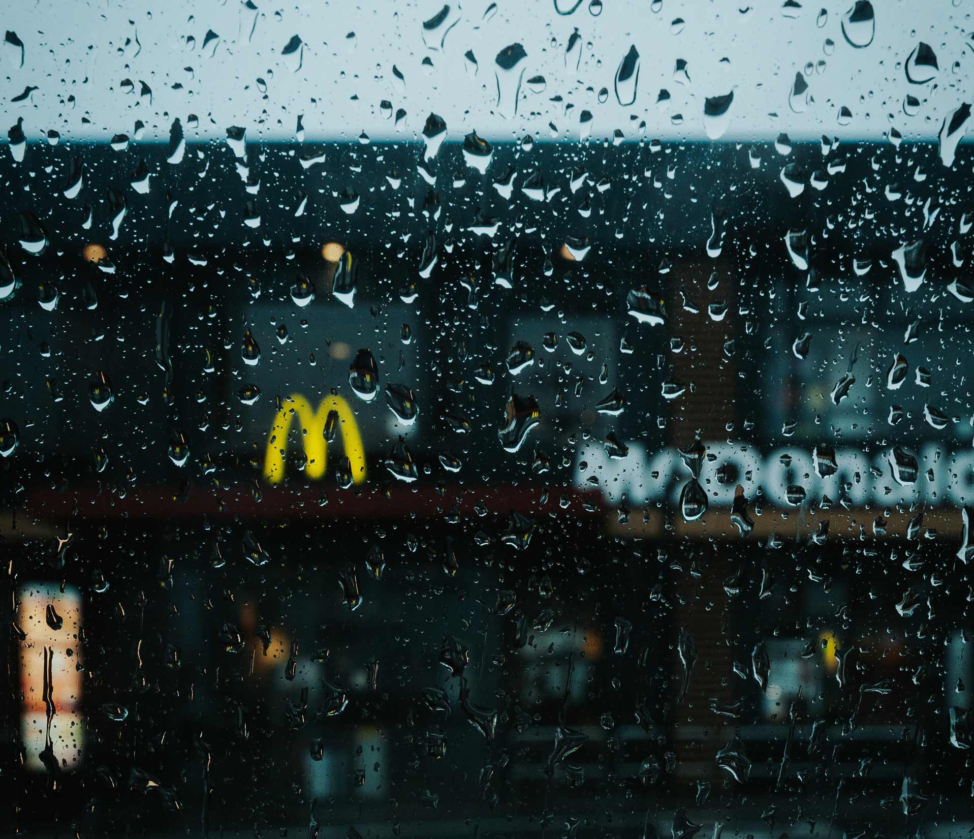 Picture of McDonald's restaurant through a rain covered window