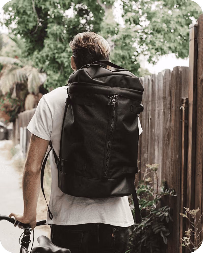 Everyman Hero Image. Man Wearing a sturdy bag with a bicycle