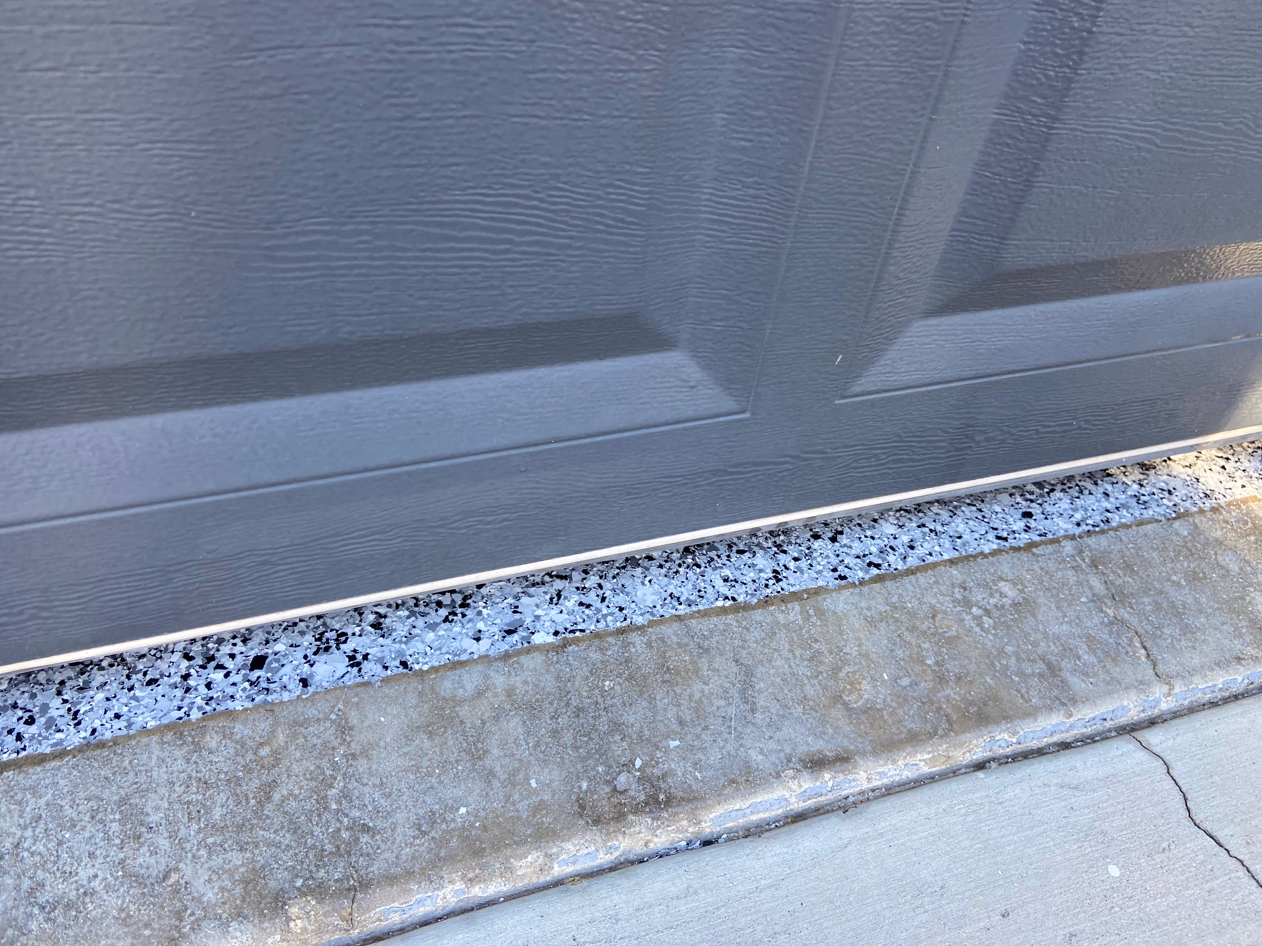 Front lip of garage with epoxy flooring