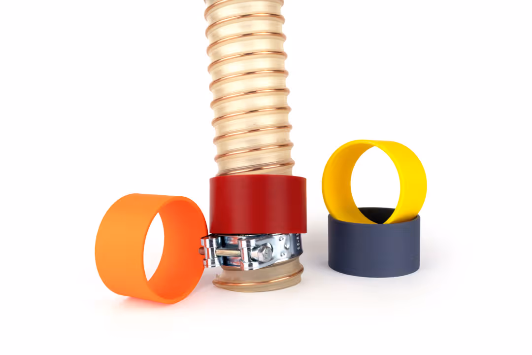 Farbige Schlauchringe in orange, dunkelrot, gelb und dunkelgrau zur farblichen Markierung von Schläuchen.