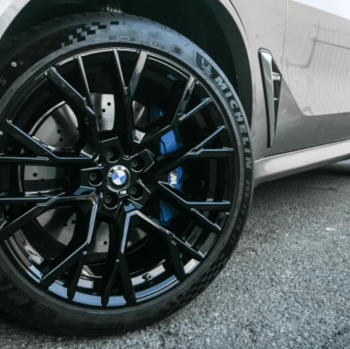 Gloss black powder coated BMW wheel with blue brake caliper, wheel powder coating in New Jersey