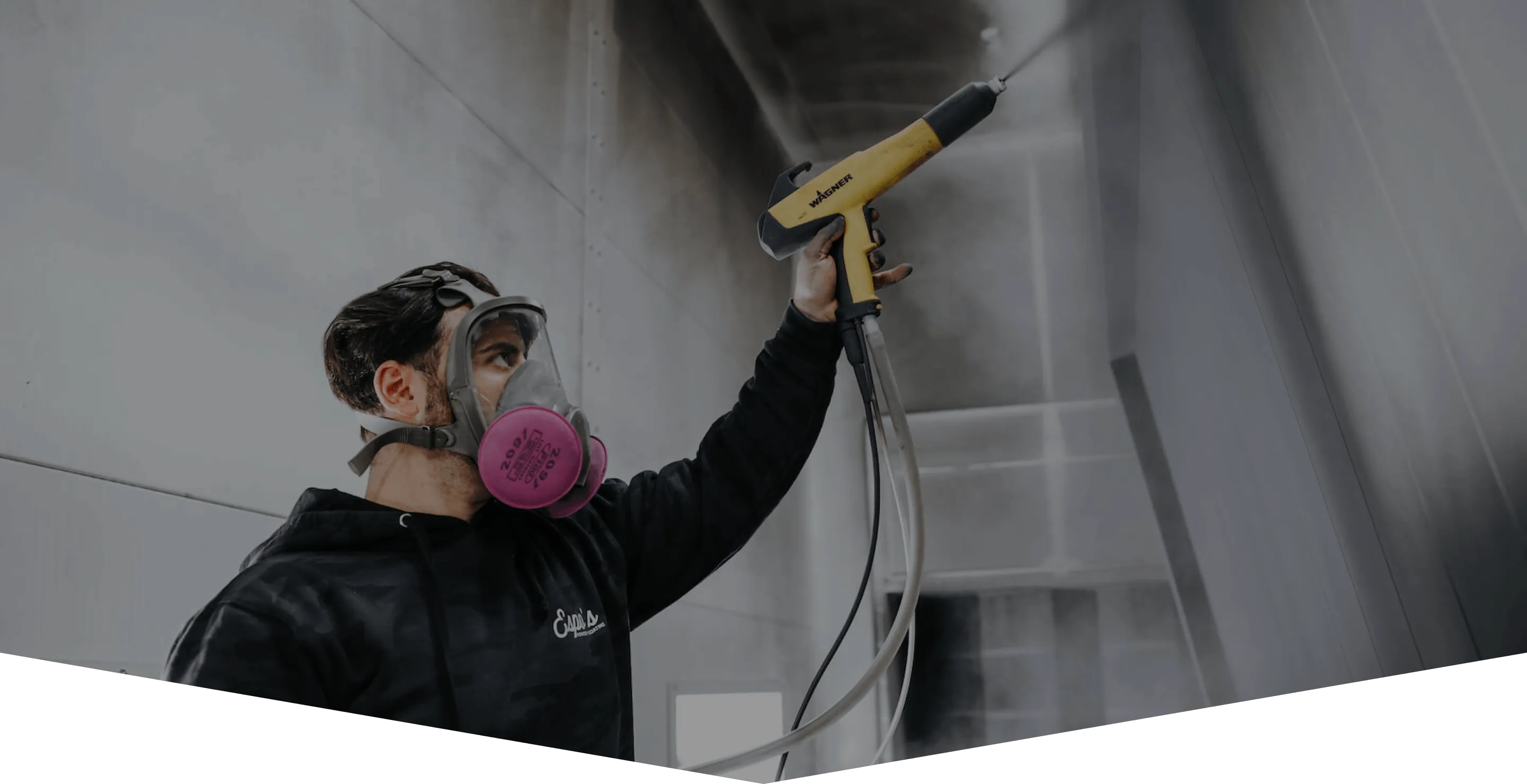 Espo's technician powder coating a part inside the spray booth in New Jersey