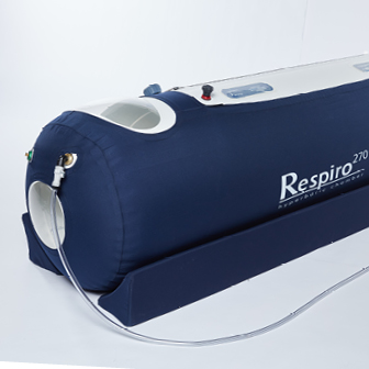 Close-up of a Respiro 270 medical air compression device with a dark blue cover and attached tubing.