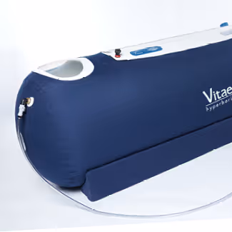 Blue and white Vitaeris Hyperbaric oxygen therapy chamber with a rounded front and coiled hose.