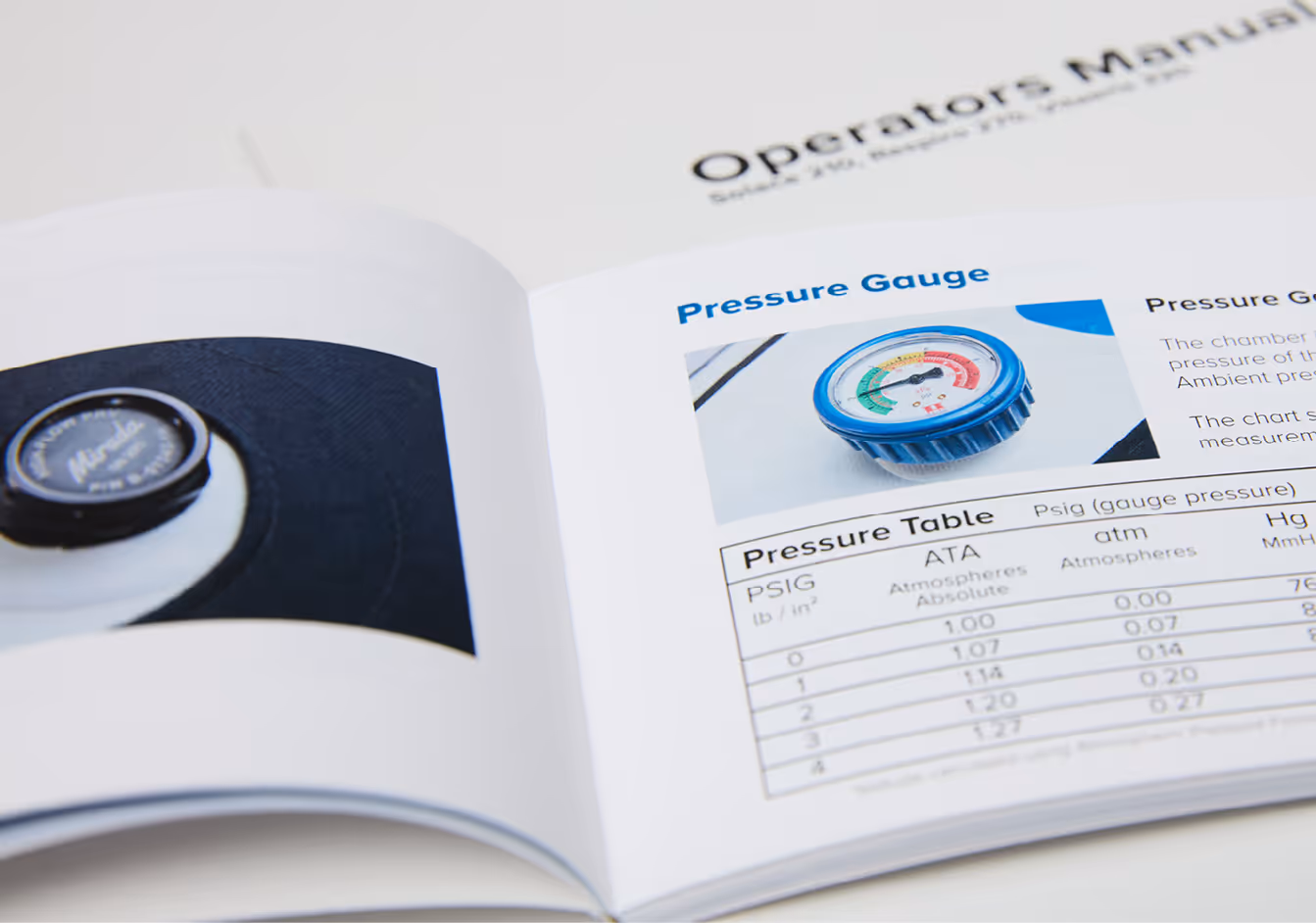 Open technical manual showing a section on a pressure gauge with an image of the gauge and a pressure conversion table.