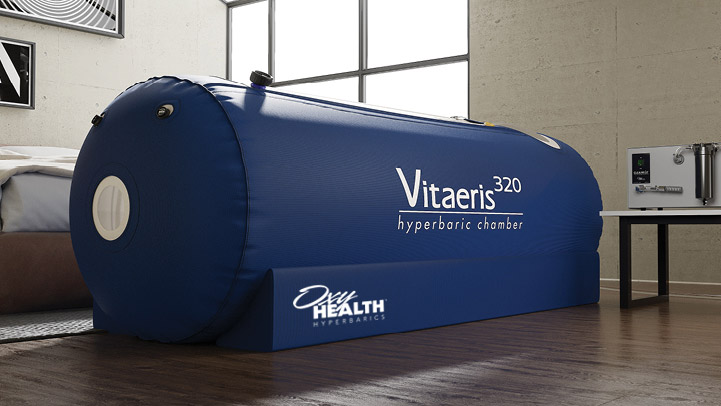 Blue Vitaeris 320 hyperbaric chamber set on wooden floor in a modern room with large window.
