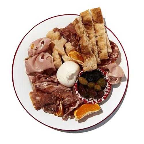 Photo of a salumi platter with bread, meats, burrata and olives