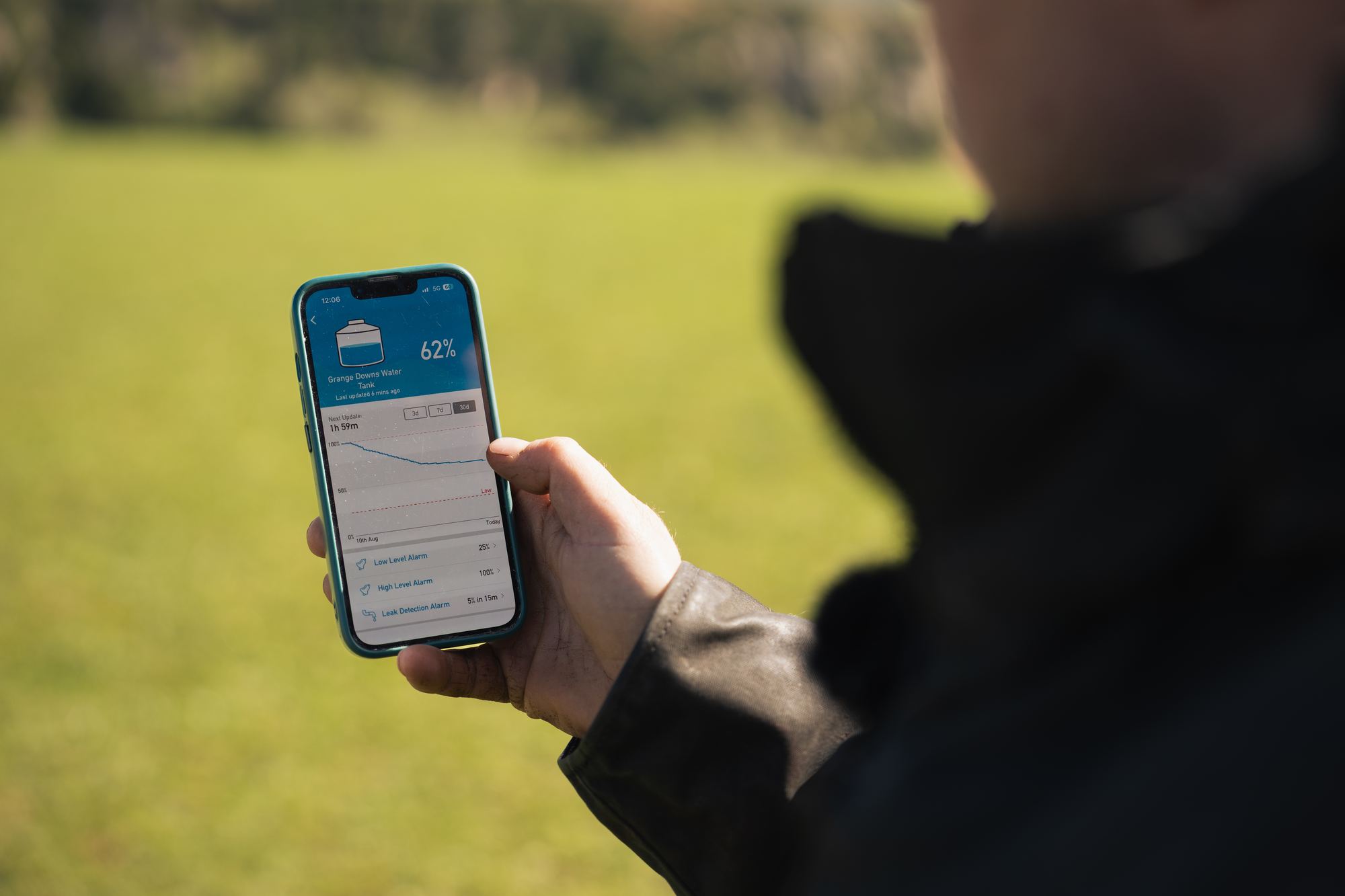 Farmer checking a tank level in the HiLo app on his phone