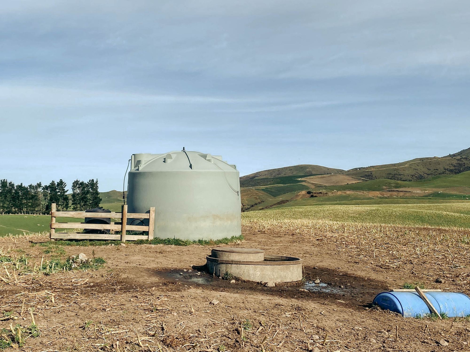 Farm water tank with a HiLo monitor on top, next to a stock trough