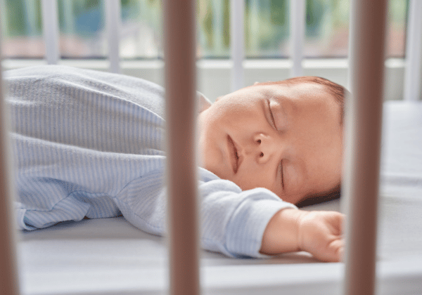 Baby sleeping in a cot
