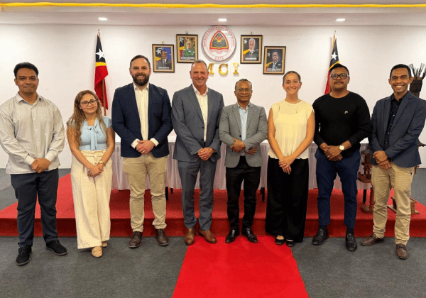 International team members posing next to Timor representatives