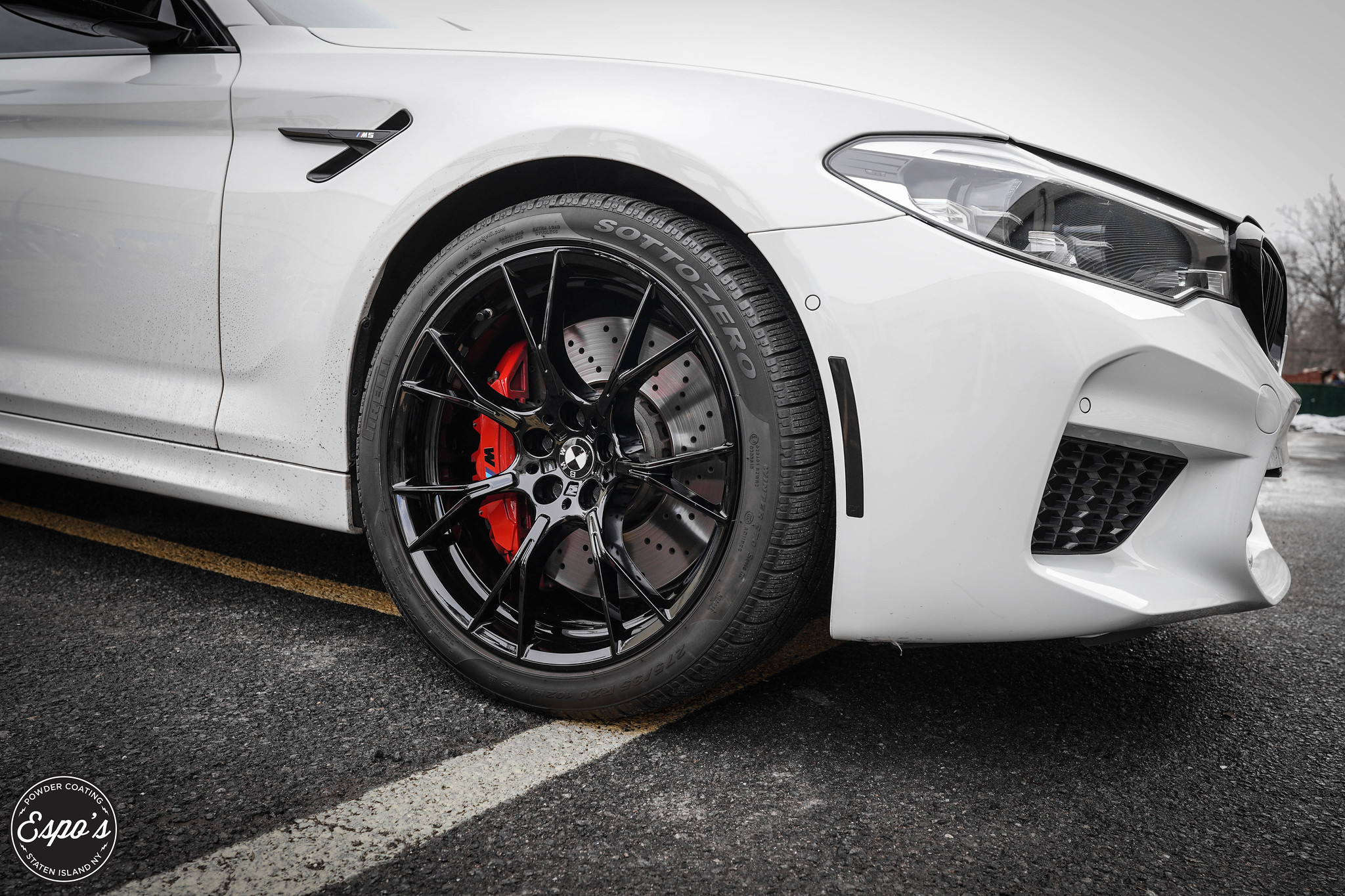 White BMW M5 on gloss black powder coated wheels with red calipers, done by Espo's in NJ