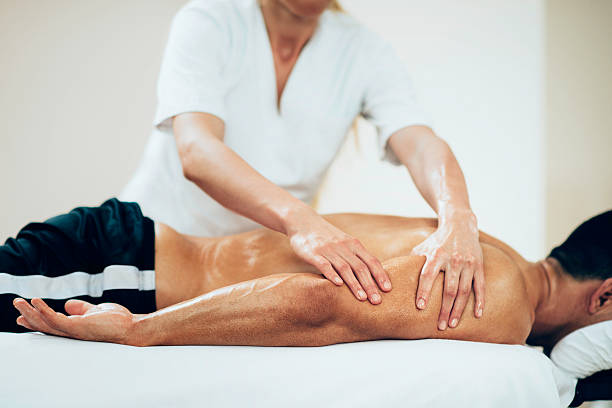 Sports massage - Massaging Arms Sports massage - Arm massage - Physical therapist doing massage of arms. Toned image, selective focus set on hands. sports massage stock pictures, royalty-free photos & images
