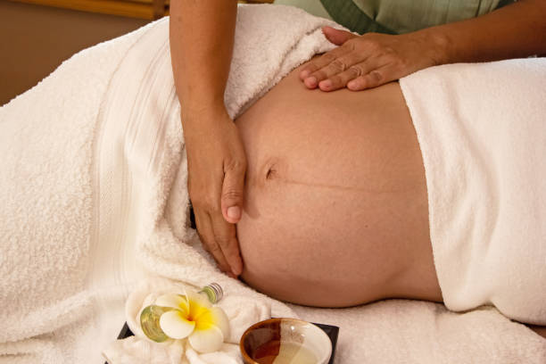 The therapiist hands massaging pregnant woman,for treat and relax program,at spa therapy The therapiist hands massaging pregnant woman,for treat and relax program,at spa therapy pregnancy massage stock pictures, royalty-free photos & images