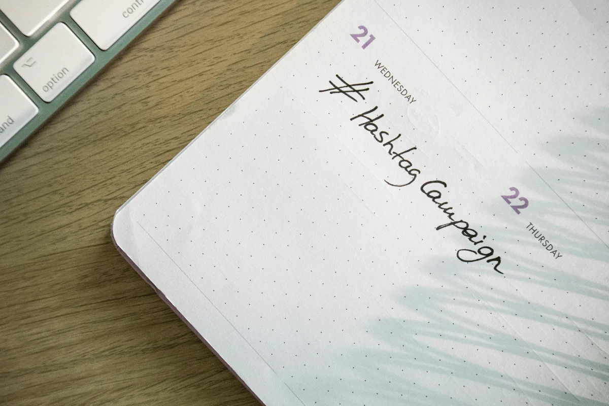 Open planner showing dates 21 and 22, with "Wednesday" noted and "Hashtag Campaign" written in cursive on the page.