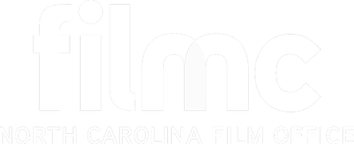 Text logo reading filmc North Carolina Film Office in white on a transparent background.