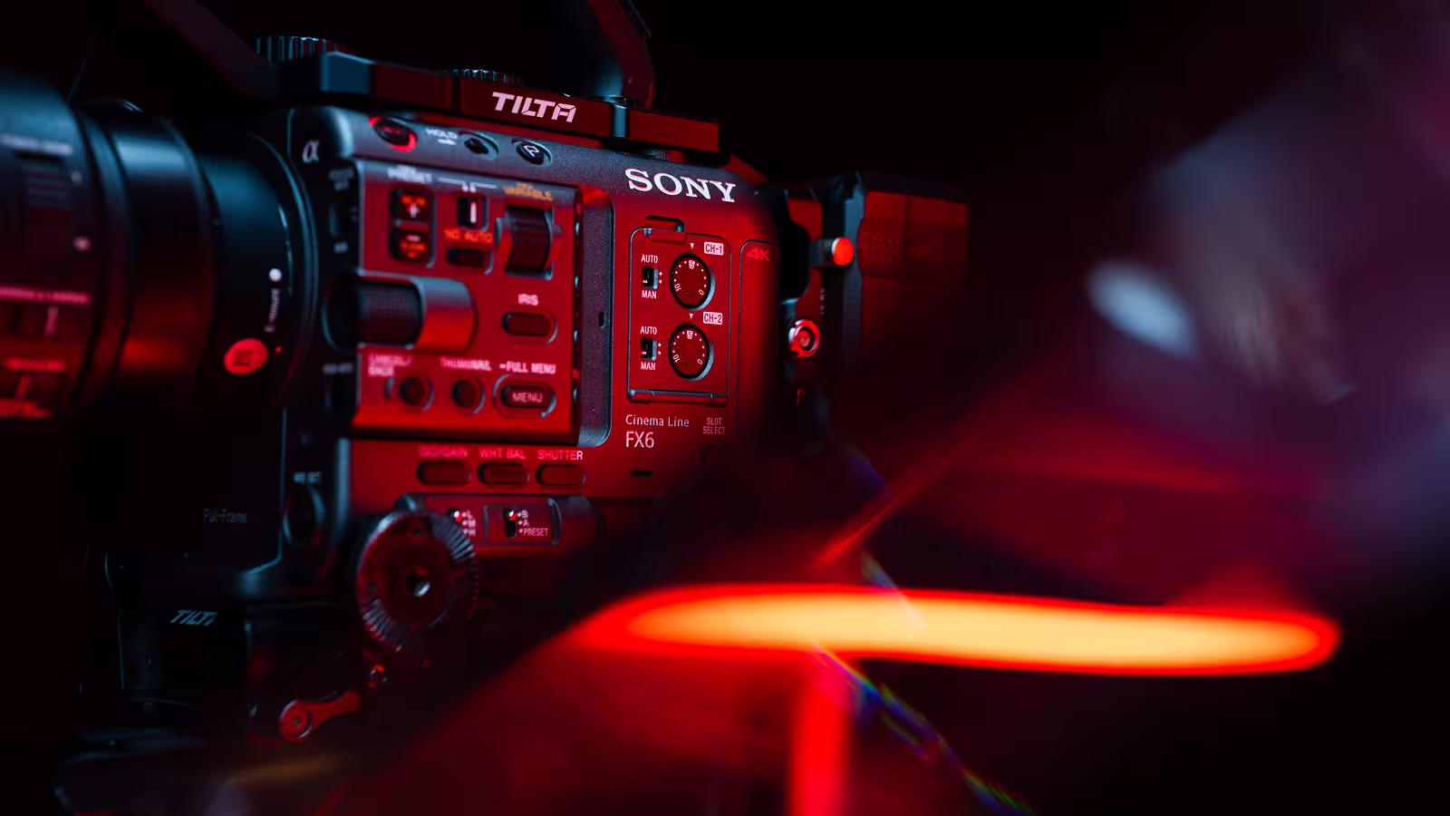 Close-up of a Sony FX6 Cinema Line camera under dramatic red and purple lighting.