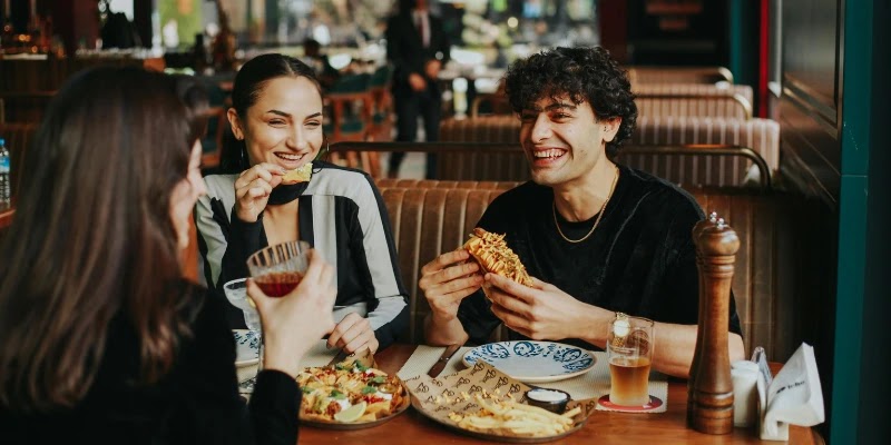 Friends enjoy fresh pizza and drinks after axe throwing in Melbourne CBD