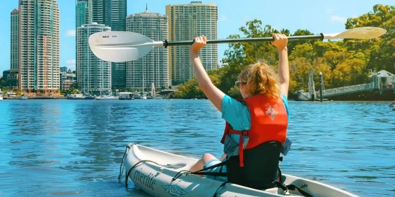 Young girl proudly kayaks with Riverlife Adventures down Brisbane River