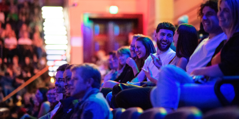 A couple laughs at a Melbourne International Comedy Festival Event.